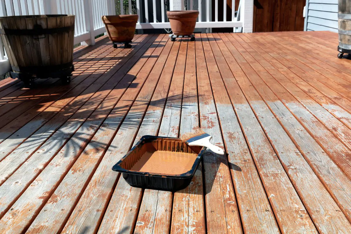 Expert Deck Contractor Staining an Old Deck