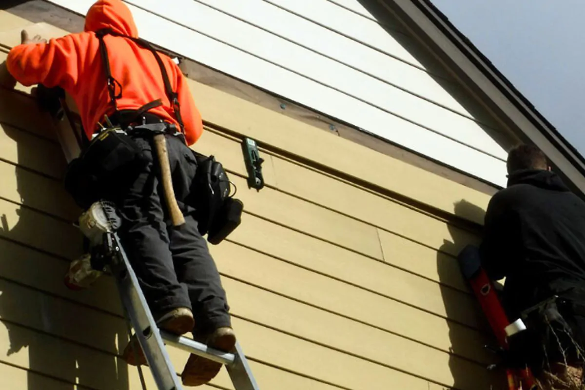 Two Contractors Repairing Exterior Siding in Wasilla, AK