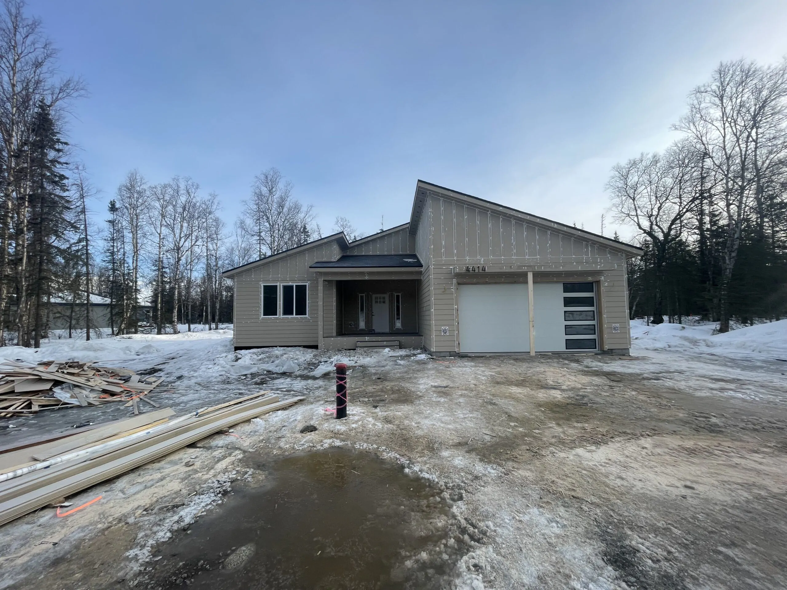 house in winter with newly installed siding