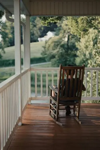 kid sitting on the porch with railings